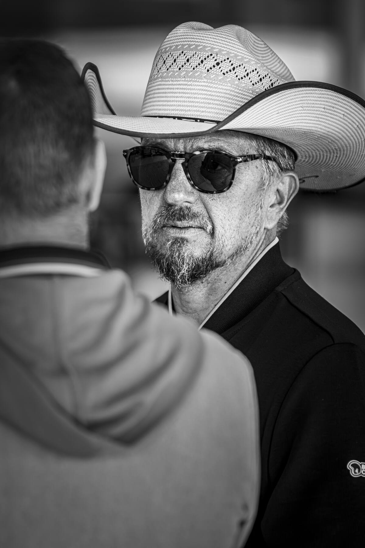 Portrait noir et blanc de Jean-Pierre Gagick au chapeau de cowboy, paddock des 2 Tours d'Horloge 2025
