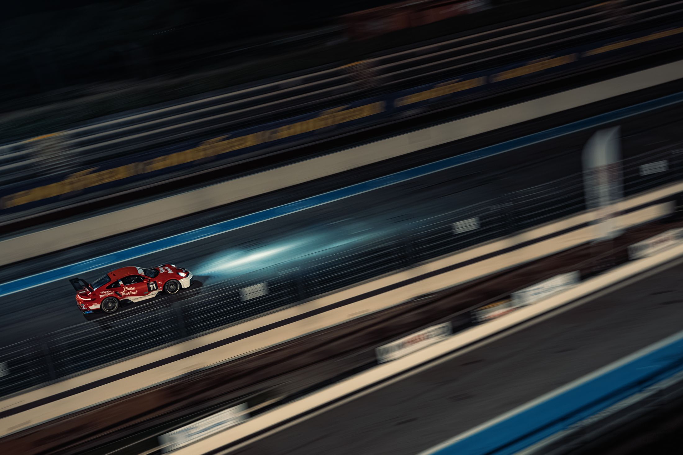 Voiture rouge en filé de nuit, traînées de lumière